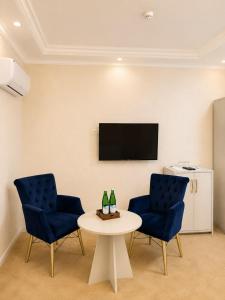 a room with two chairs and a table and a tv at HUMO PLAZA in Fergana +28 photos