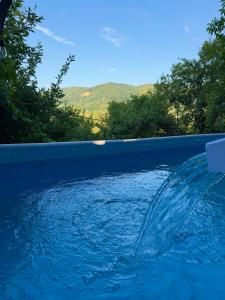 a swimming pool with a splash of water at Casa NIB Calimanesti in Călimăneşti +32 photos