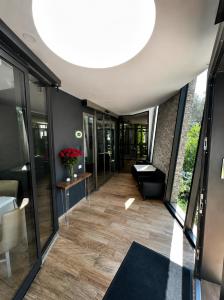 a hallway in a building with a large ceiling at Athos Hotel in Riva del Garda +121 photos