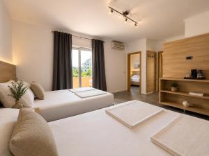 a hotel room with two beds and a couch at Villa Illyria in Donji Štoj