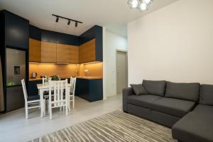 a living room with a couch and a table at MaisonNova Deluxe 2 in Tirana