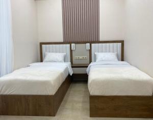 two beds in a small room with at Makaryan Resort in Artsvaberd