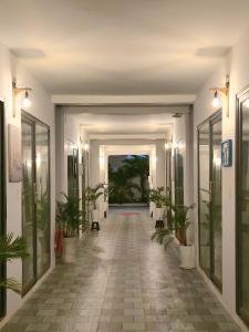 a hallway with potted plants in a building at Fla Village in Phú Quốc +76 photos