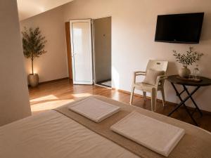 a bedroom with a bed and a table and a chair at Villa Illyria in Donji Štoj