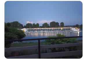 a large boat on a river in the water at Les pieds dans l'eau Pergola in Fleurville