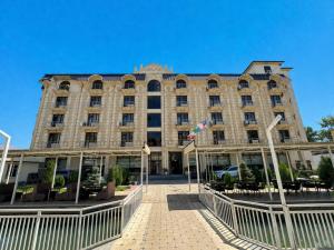 a large building with a fence in front of it at HUMO PLAZA in Fergana