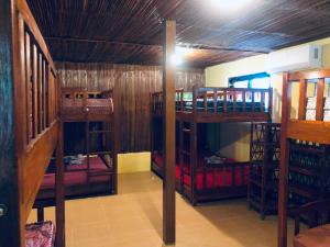 a room with three bunk beds in a house at daTerra Vilaverde in Dili