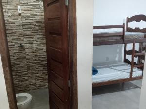 a room with a bunk bed and a toilet at Pousada Nordestino in Salinópolis