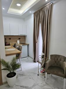 a kitchen with a table and chairs in a room at Studio centar Lazic 1 in Šid