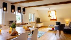 a dining room and living room with a table and chairs at Ferienwohnung Fuchsfelsen, perfekt für Familien mit Kindern in Häusern