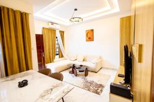 a living room with a couch and a table at Luz RÉSIDENCE in Abomey-Calavi