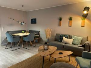a living room with a couch and a table at Ferienwohnung Sundkieker Fehmarn in Fehmarn