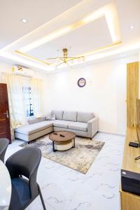 a living room with a couch and a table at Luz RÉSIDENCE in Abomey-Calavi +8 photos