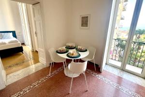 a dining room with a table and chairs and a balcony at Villa Lucia in Torre del Greco
