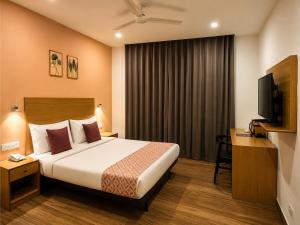 a hotel room with a bed and a television at Hotel The Golden Sands, Located on Calangute Main Road in Calangute