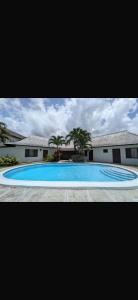 a large blue swimming pool in front of a building at Reef Winds Villa in Runaway Bay