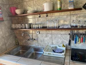 a kitchen sink with a dish drying rack next to it at Keetmanshoop Self-catering in Keetmanshoop +21 photos