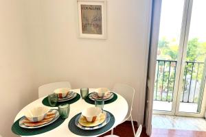 a white table with plates and cups on it at Villa Lucia in Torre del Greco