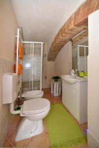 CastellʼAlferoにあるcasa del miglioのバスルーム(白いトイレ、シンク付)