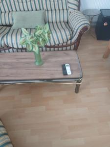 a living room with a couch and a remote control on a coffee table at Aleksinac Centar Two-Bedroom Apartment in Aleksinac