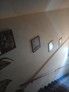 a stairway with three pictures on the wall at Aleksinac Centar Two-Bedroom Apartment in Aleksinac