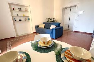 a living room with a table and a blue couch at Villa Lucia in Torre del Greco +47 photos