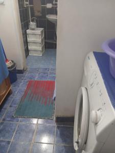 a laundry room with a washing machine and a tile floor at Aleksinac Centar Two-Bedroom Apartment in Aleksinac