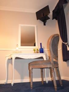 a white dressing table with a chair and a mirror at Balally House in Shannon