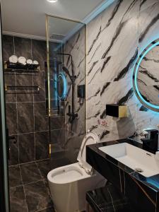 a bathroom with a toilet and a sink and a shower at Furaton Hotel in Ðức Hòa +48 photos