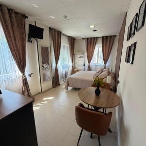 a hotel room with a bed and a table in a room at Residencia Porta Nova in Ferrol