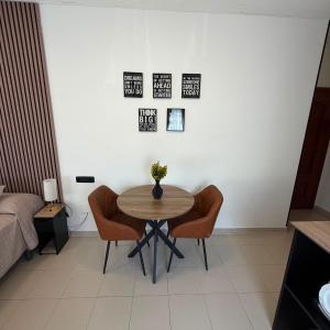 a table and chairs in a room with a bed at Residencia Porta Nova in Ferrol +58 photos