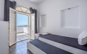 a bedroom with a bed and an open door at Mylopota apartment IIΙ in Mylopotas