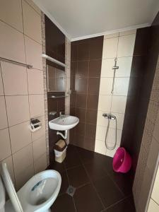 a bathroom with a sink and a toilet and a shower at Къща за гости "Пердика" in Obzor +47 photos