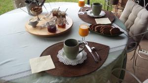 a table with two plates of food and coffee on it at Marievalerianne in Mirefleurs