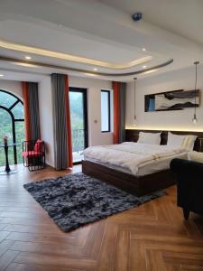 a bedroom with a large bed and a large window at Furaton Hotel in Ðức Hòa