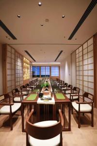 a large conference room with a long table and chairs at Secluded Comfort City Resort Hotel in Hangzhou