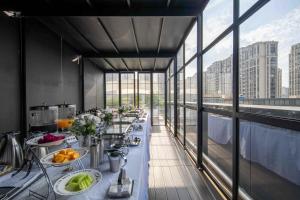 a room with a long table with food on it at Secluded Comfort City Resort Hotel in Hangzhou