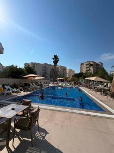 a large swimming pool with people swimming in it at Hotel Roden in Golem