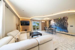 a living room with a white couch and a table at Popi's apartment in Argostoli