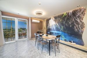 a dining room with a large painting on the wall at Popi's apartment in Argostoli