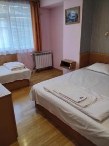 a hotel room with two beds and a window at Hotel Mehdjarel in Shumen +23 photos