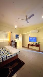 a bedroom with a bed and a flat screen tv at Platform 9 3by4 in Ujjain