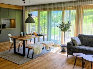 a living room with a table and a couch at Lieblingsplatz Alpine Lodge in Tschagguns