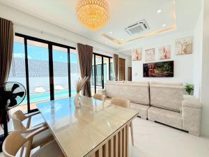 a living room with a table and a couch at Nook Villa in Ban Khlong Mae Nam
