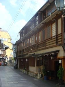 a building with wooden balconies on the side of a street at Senshinkan Matsuya in Yamanouchi