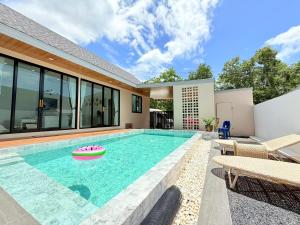 a swimming pool in the backyard of a house at Nook Villa in Ban Khlong Mae Nam
