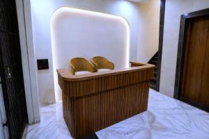 a lobby with two wicker chairs in a white room at Raahi Home Stay Near Iskcon temple & Pushpa Mission Hospital in Ujjain