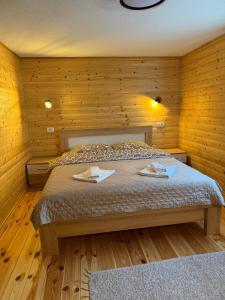 a bedroom with a bed with two towels on it at Apartman Bakic in Kolašin