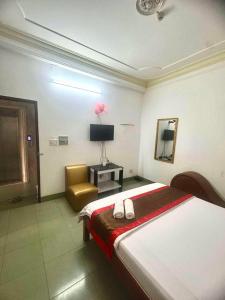 a bedroom with a bed and a chair and a television at HoTeL Long Phụng 1 Quận Bình Tân in Ho Chi Minh City