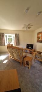 a living room with a couch and a table at Blackberry Cottage, Wood Farm in Shipdham